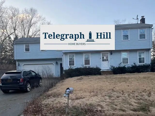 Blue split-level house with a Telegraph Hill sign on the lawn
