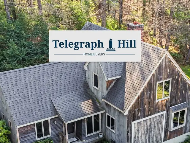 Weathered shingled house among tall trees