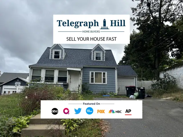 Gray-blue cape-style house with a Telegraph Hill sign